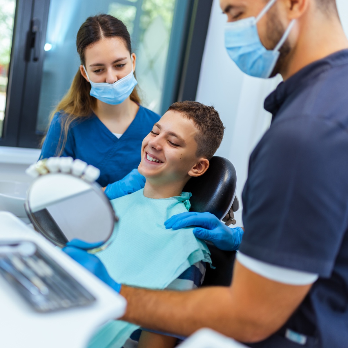 A dentist showing a happy patient our dental recordkeeping app